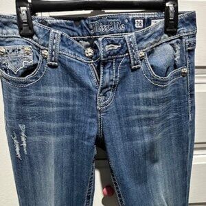 Women's Miss Me Jeans with black and white cow print pockets